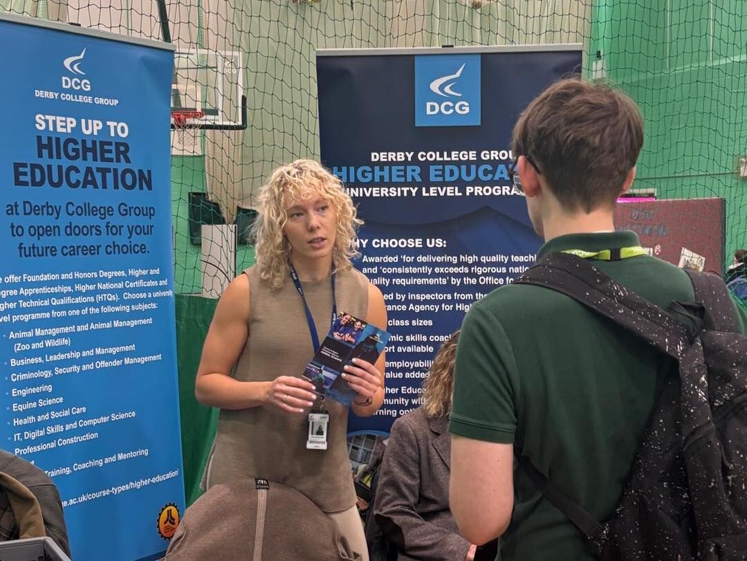 “Students speaking with a university representative at a higher education insight event, with banners promoting university level courses in animal care, equine studies and dog grooming, supporting progression into higher education.”