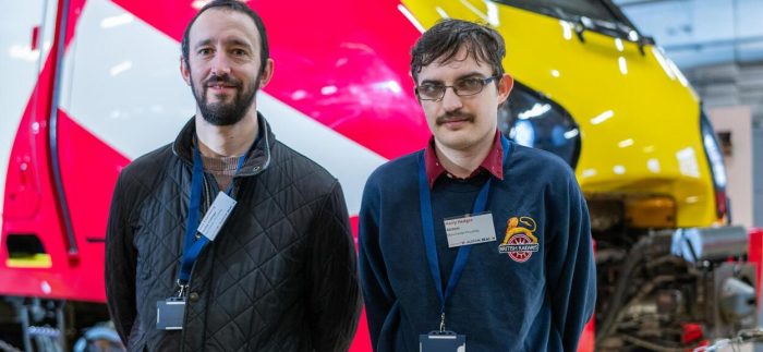 Derby College Group and Alstom staff stood in front of a train.