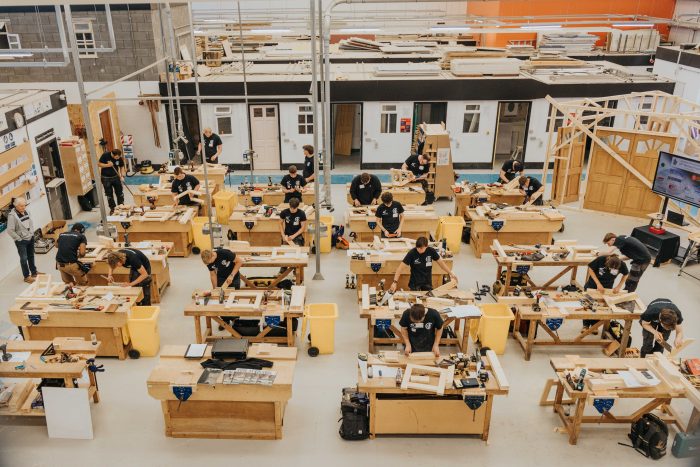 Many carpentry students working at their own stations at The Marlene Trophy.