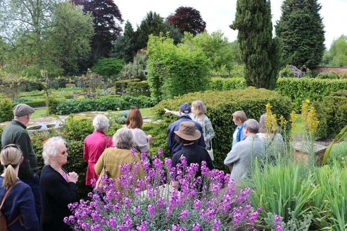 Visitors exploring the gardens at Broomfield Hall during a Rare Plant Fair event, with landscaped planting and flower borders.