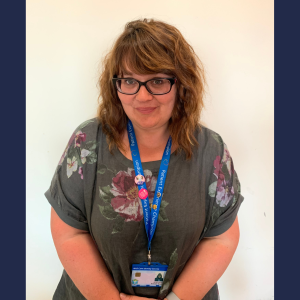 Learning and Development Advisor wearing a lanyard and ID badge, standing indoors during a Level 3 Fast Track Teaching Award case study