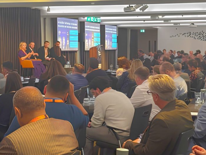 Audience listening to a panel discussion at the Training and Technology Summit in London, focused on AI, accessibility and education technology