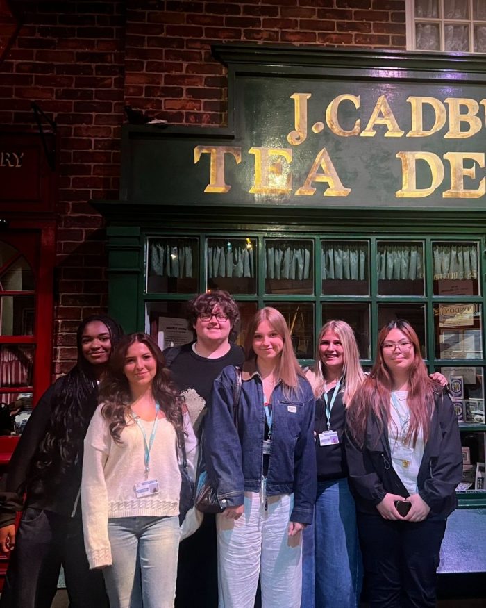 Derby College Group students visiting Cadbury World and standing in front of a historic shop display during Project Week