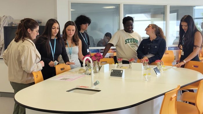 Derby College Group T Level Science students talking to each other whilst working on their project