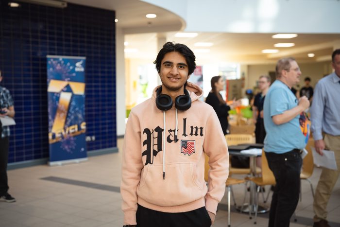 A-level student Amarjit at Results Day wearing a pink hoodie with the USA flag on.