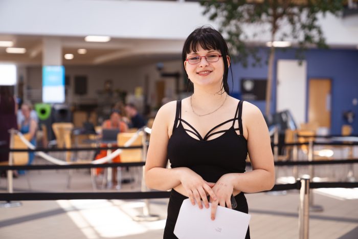 Derby College T Level student Emilia Wuss holding her results.