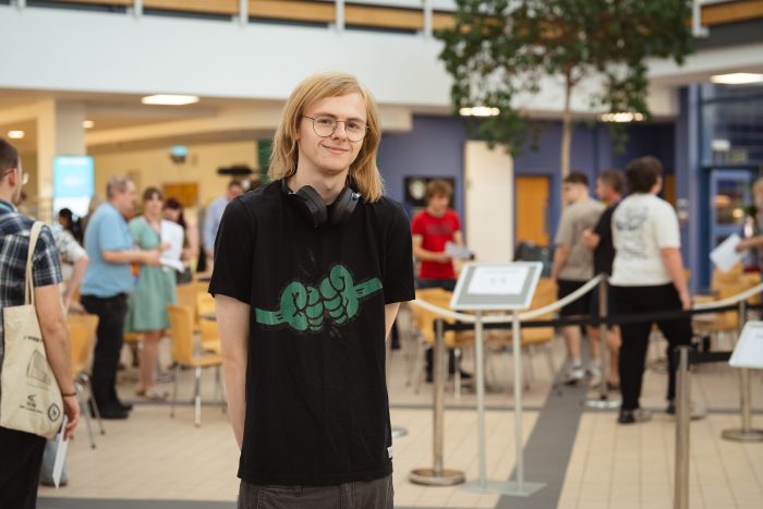 Derby College T Level student Konrad Halsey wearing a black t shirt.