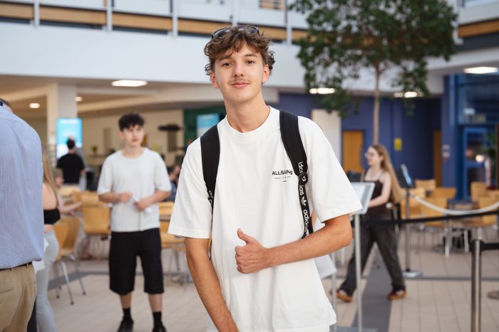 Derby College T Level student Rhys Allen holding his results.