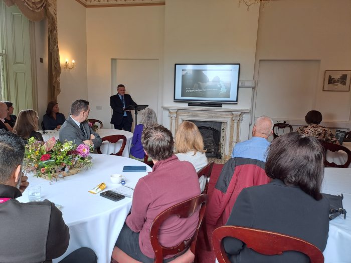 Derby College Vice Principal Jon Collins delivering a presentation to a room of engaged delegates.