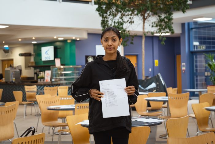 Derby College student Rajasi Soni holding her GCSE results