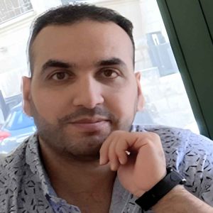 Adult learner at Derby College Group Mouaead sat down wearing a floral shirt and a black watch