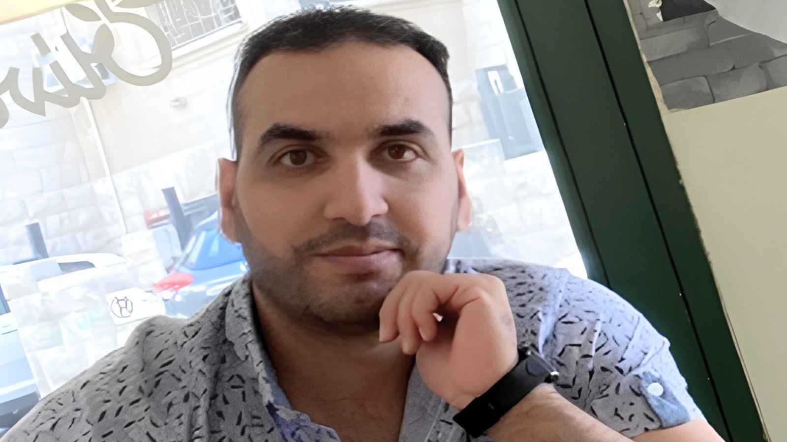 Adult learner at Derby College Group Mouaead sat down wearing a floral shirt and a black watch